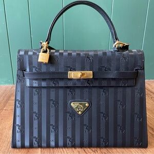 Rare Madison Mollerus MM European handbag. In black and gold with embossed logo.